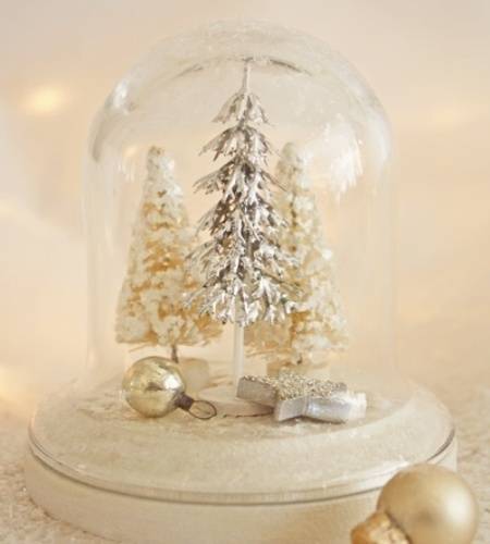 A bell jar having Christmas tree and fever decorative items.