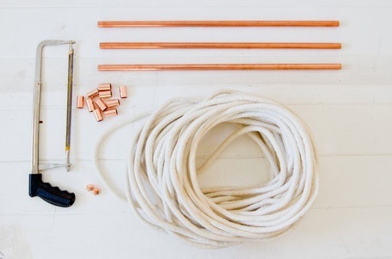 Copper pipe with copper bits, a hacksaw, and a coiled rope.