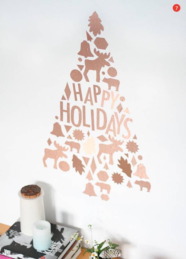 Vinyl Christmas tree with the words "Happy Holidays" with moose, bells, bear, leaves, and bells creating the Christmas tree pattern.