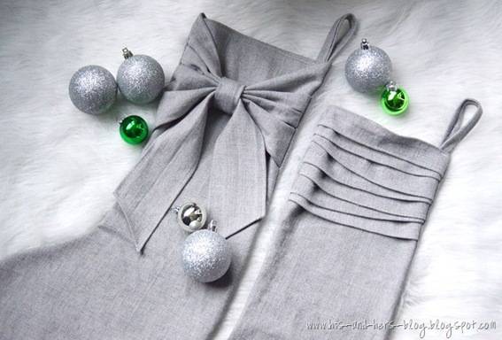 Silver Christmas stockings with ruffled edges and Christmas ornaments.