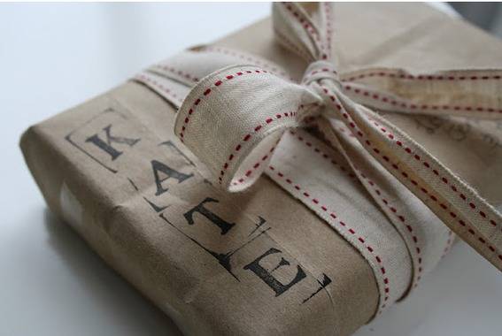 A wrapped present is stamped with the receiver's name in large black letters.