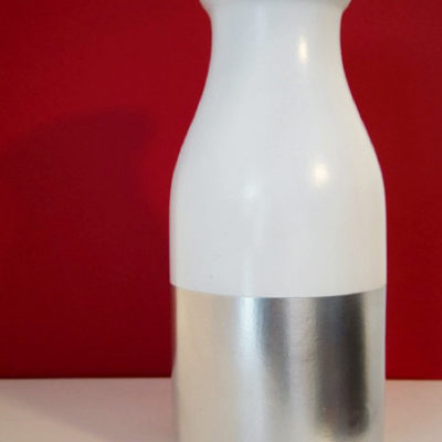 Milk bottle colored with white and silver paints to make vase.