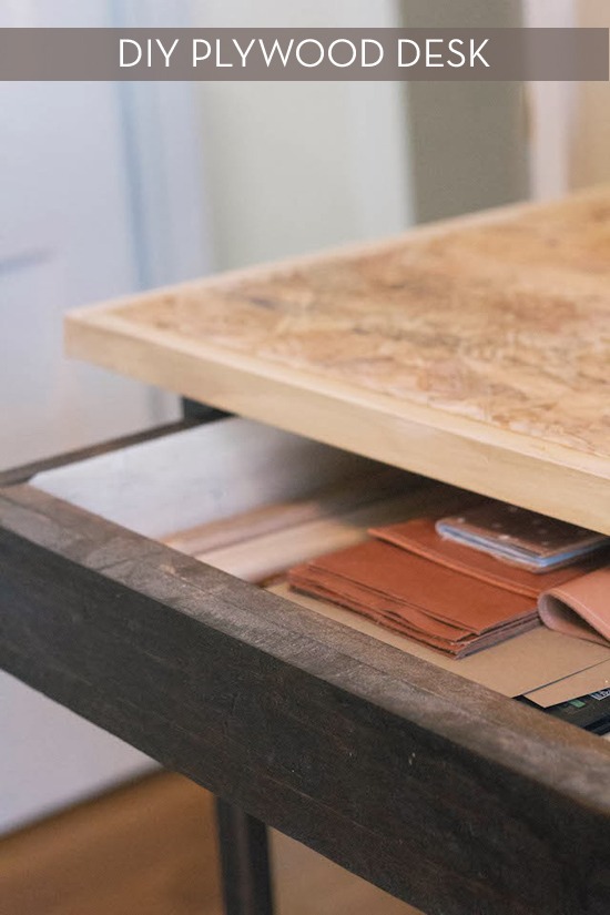 Wallet inside a drawer of a plywood desk.