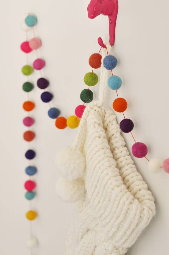 Colorful beads are hanging on the wall for decoration purpose.