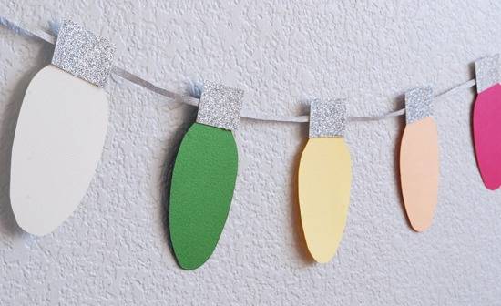 A paper decoration in the likeness of colorful Christmas lights.