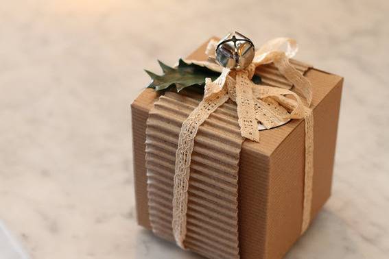 Small brown gift box with a decorative bow on top.