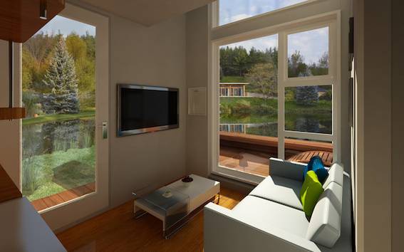 A stark living room with a light blue square sofa, a white coffee table and sunlight streaming through giant windows.