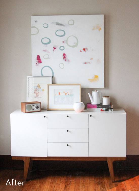 Storage cabinet with a large canvas painting behind it.