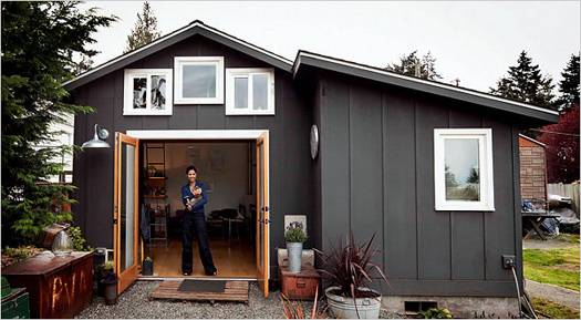 Woman standing in opening of French door in a tiny home.