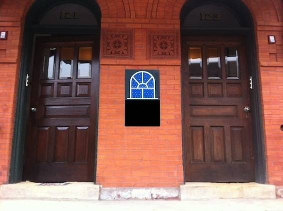 Two large wooden doors in a brick building.