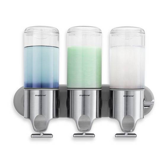 Three soap dispensers having different color liquid soap in them.