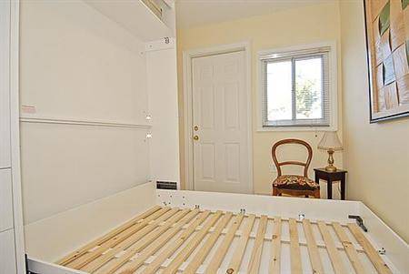 Bed with wood bed slats in a bedroom.
