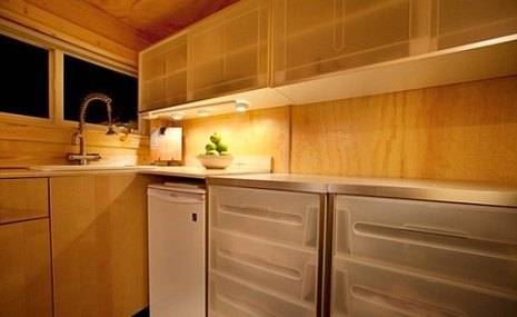 Wooden kitchen platform brightened with spotlights.