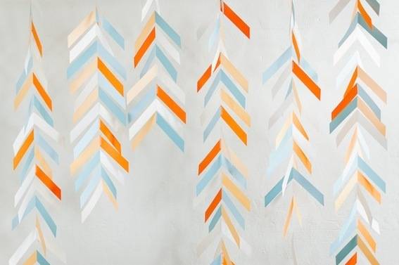 Decorations are made out of orange, blue and white papers.