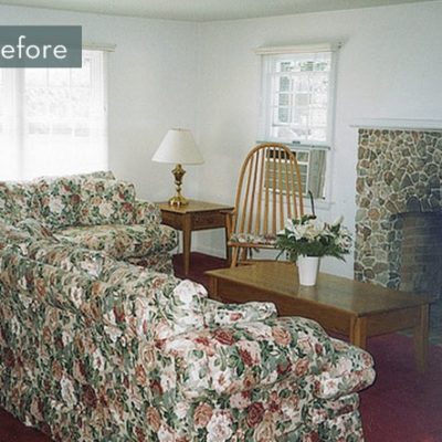 Before image of a dated living room with an old fireplace and ugly floral couches.