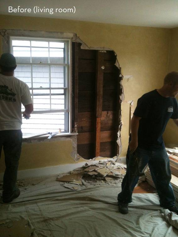 Two men demolitioning the living room.