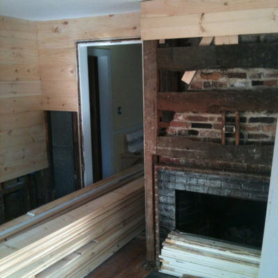 A fireplace in a room that is being remodeled.