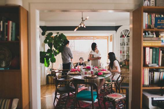 Persons are in a party which is in a room.