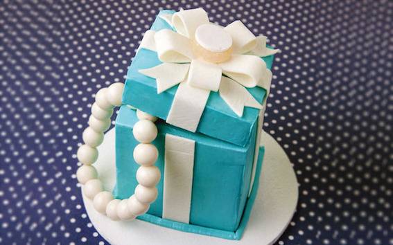 A blue box wrapped in white gift wrap
