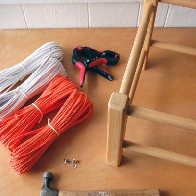 "Hammer,rope,tape and wooden stand to make woven footstool."