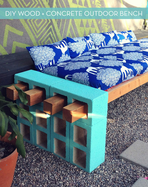 "Wooden bench with blue and white bed."