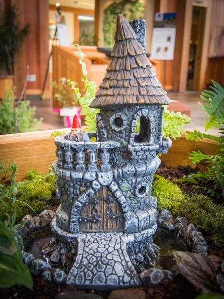 "Fairy garden home with plants and trees."