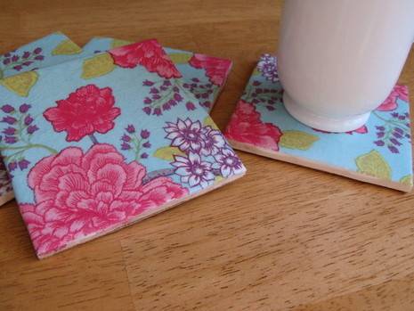 Several blue coasters with rich flower patterns on them.