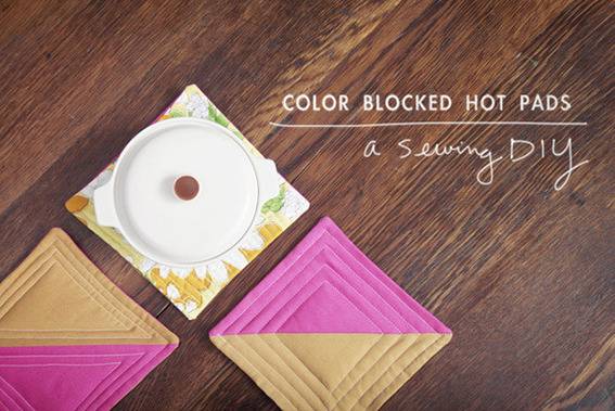 Three colorful hot pads are shown with one pot on them.