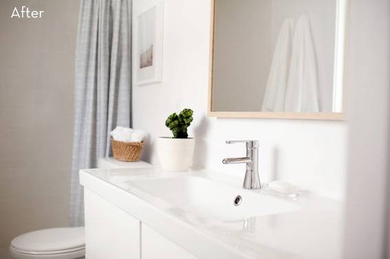 A toilet is sitting on the other side of a sink in a bathroom.