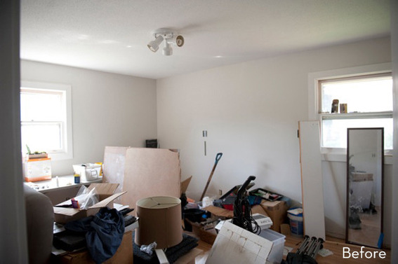 A living room is cluttered and messy.