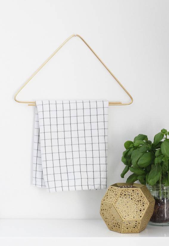 A blue and white towel hangs on a triangular hanger.