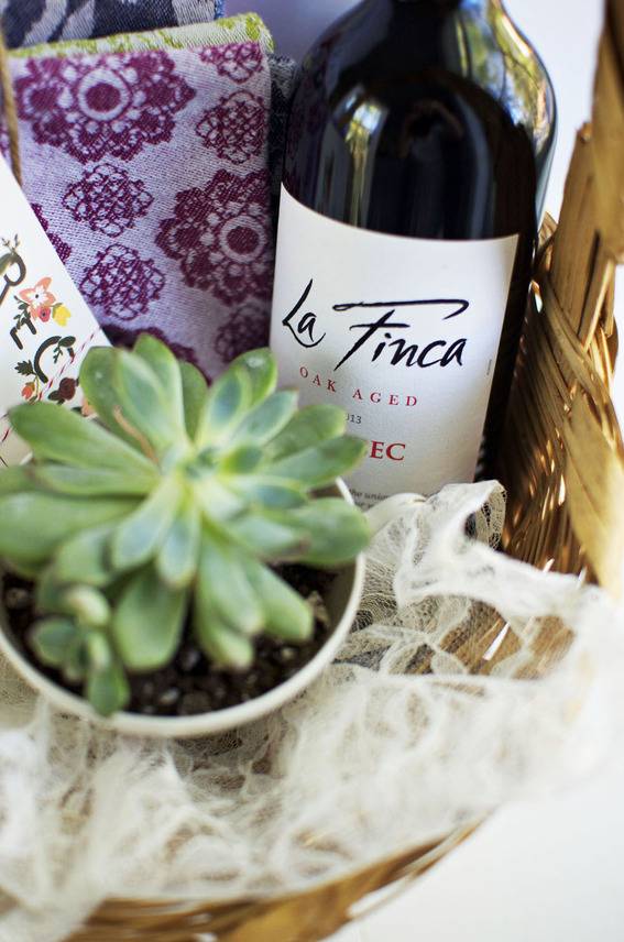 Wine sits near a planted succulent.