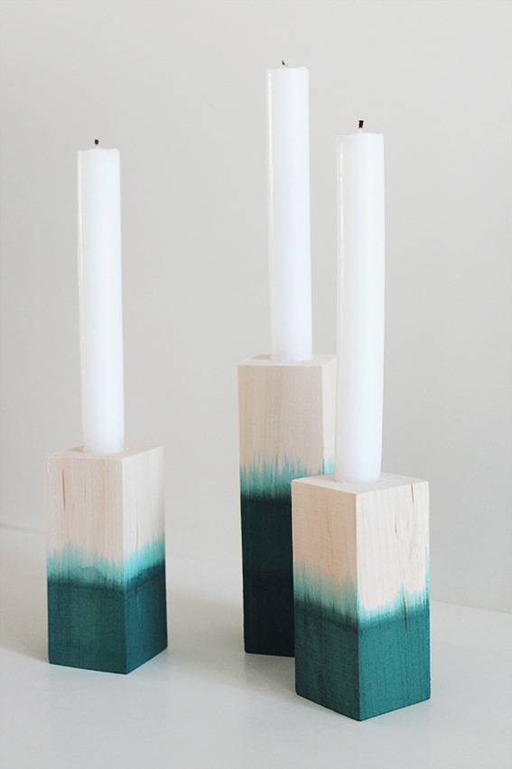 "White candles in white and blue wooden brick."