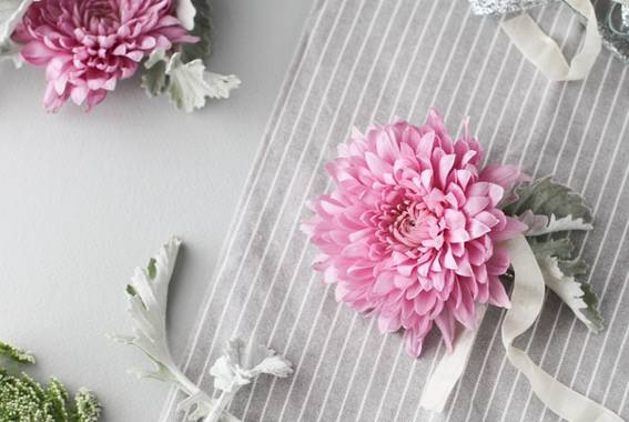 Two pink flowers are shown with a piece of fabric.