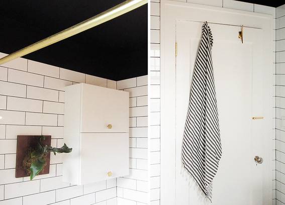 A bathroom with white brick walls and white cabinet and door.