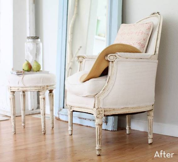 A light colored chair and ottoman sit in a room with a light colored floor.
