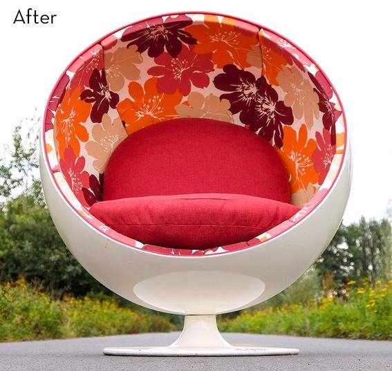 A circular chair has a red cushion and flower decor.