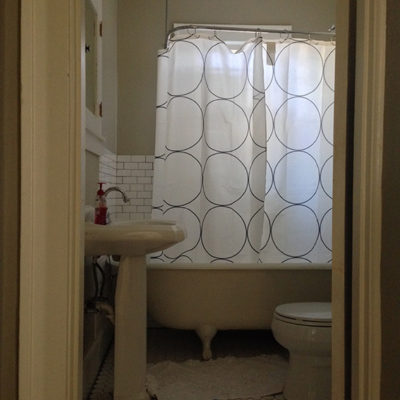 Bathroom with tub, commode toilet and washbasin.