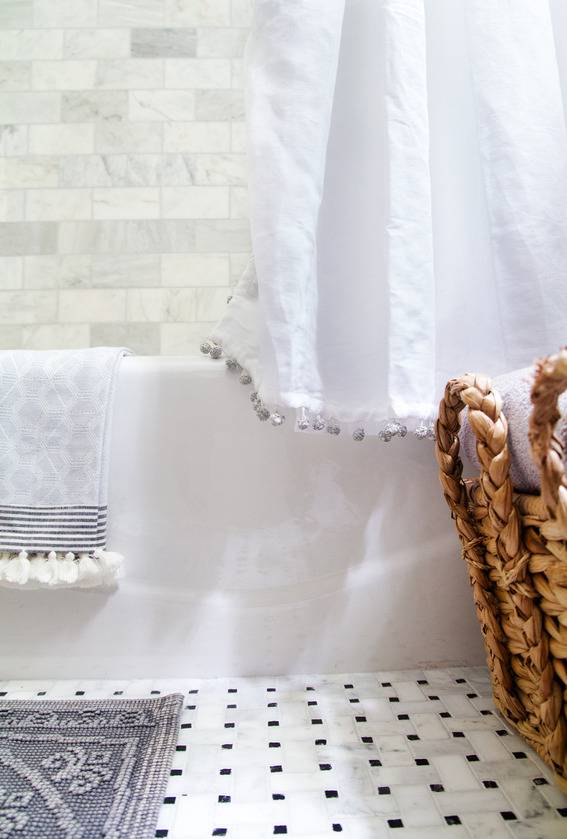 Marble subway tile shower, marble basket weave floor, & kohler tub