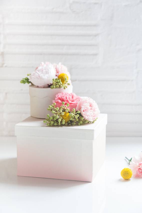 A white room has a box with pastel colored flowers on top.