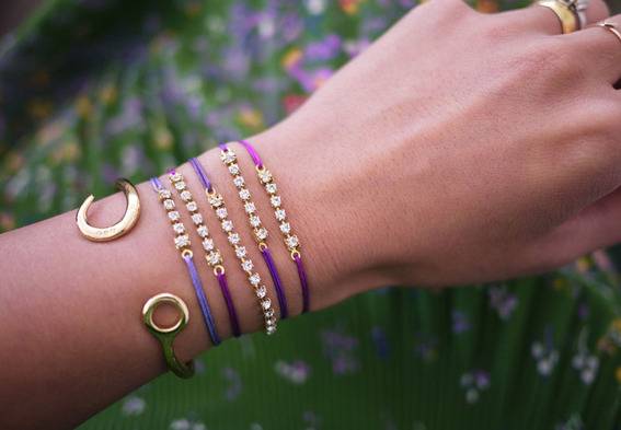 A woman is wearing jewelry on her left hand.