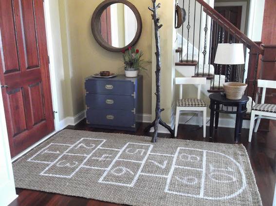 An entryway with a mat painted in numbers