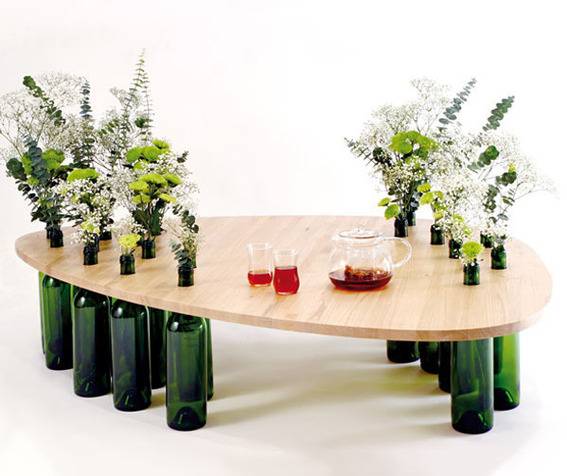 "Wine bottle coffe table with plants and wine."