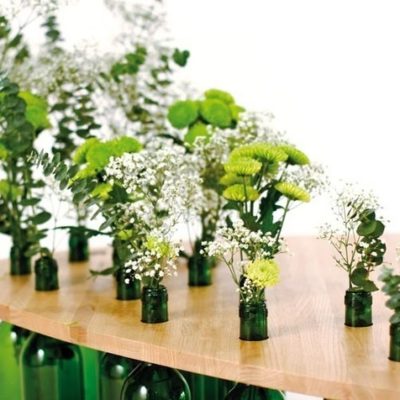 A wine bottle coffee table with flower plants