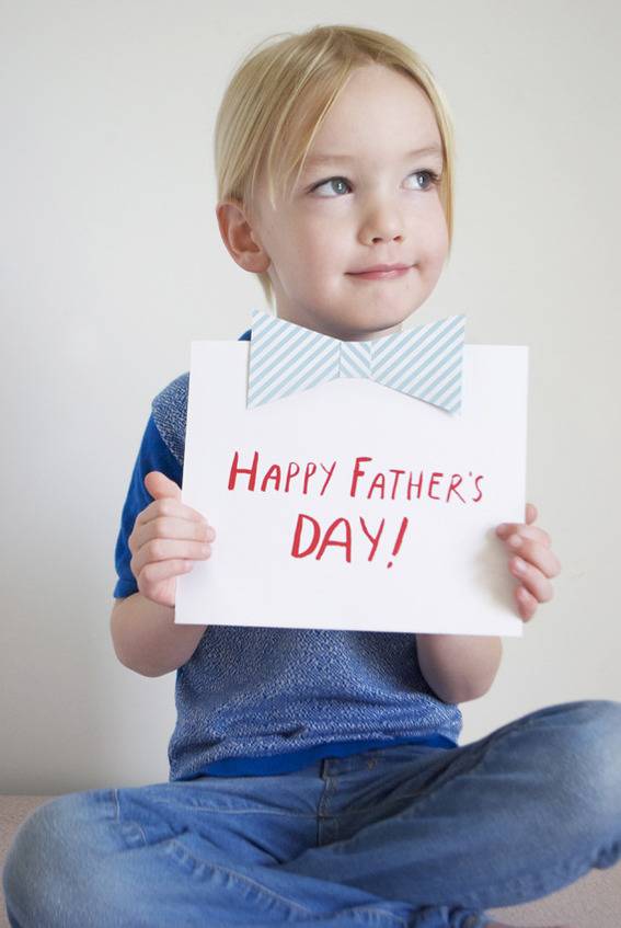 "Boy with Happy father's day pamplet."