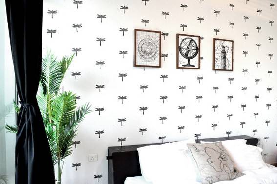 White bedroom with uniform print all over the wall.
