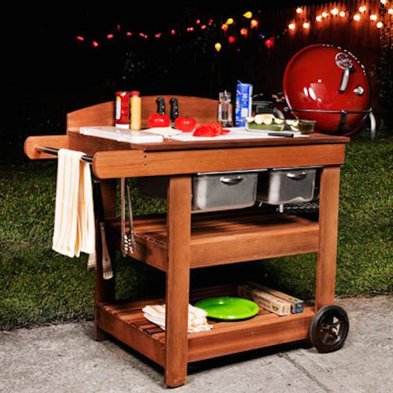 Outdoor kitchen table along with items on it.