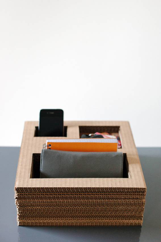 A black table has a wooden box with wallets in it.