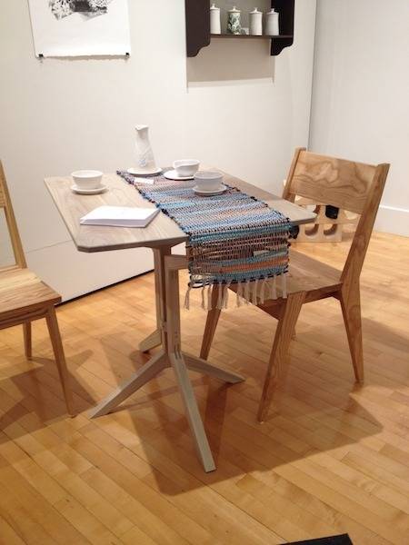 "A Small Living room with Chairs and Table made of Wood"