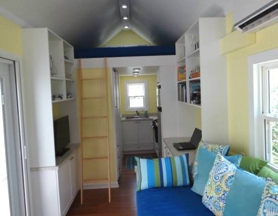 "Tiny home with cushions,laptop,tv and ladder."